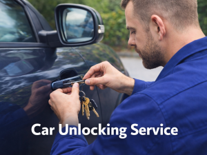 A locksmith in a blue uniform uses a tool to unlock a car door.